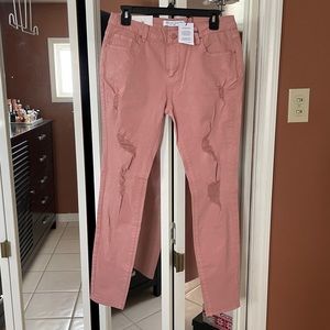Mauve colored distressed jeans
